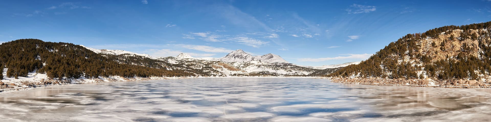 panoramic view of frozen lake in Pyrenees mountains