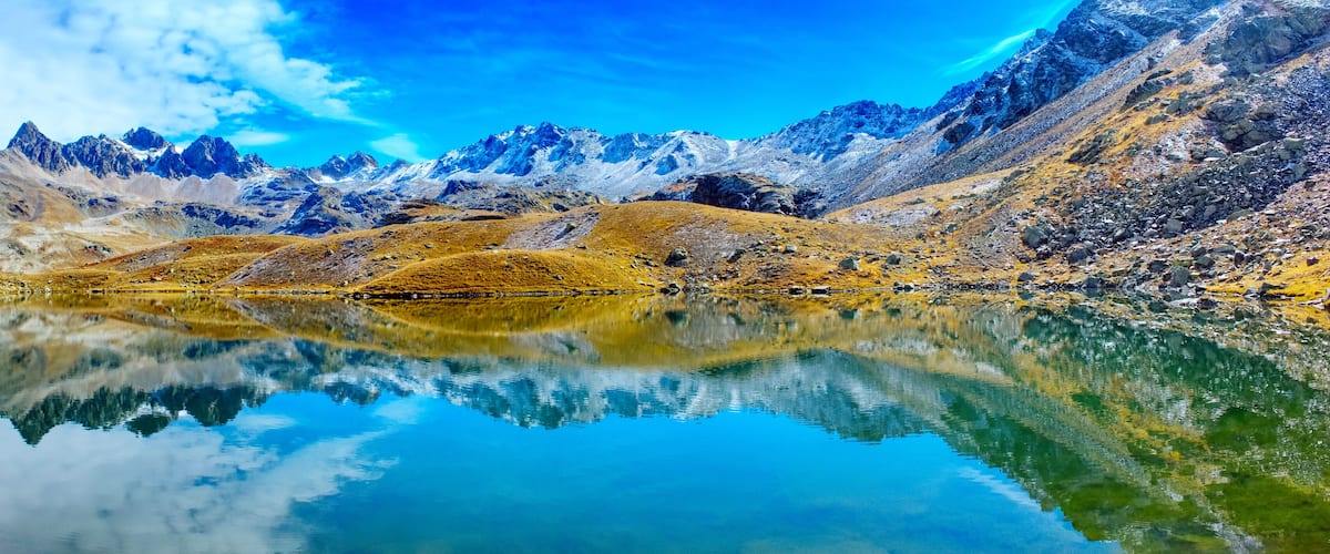 A mountain range with a clear lake reflecting the peaks.