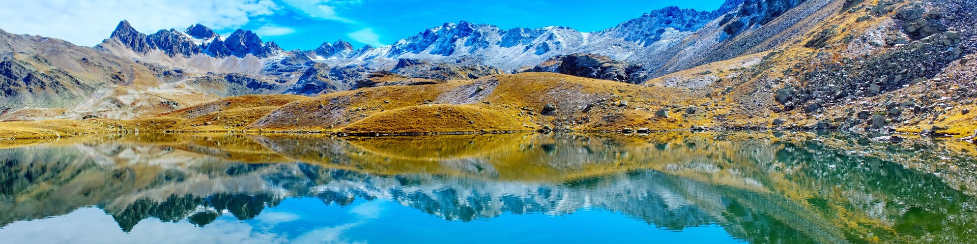 A mountain range with a clear lake reflecting the peaks.
