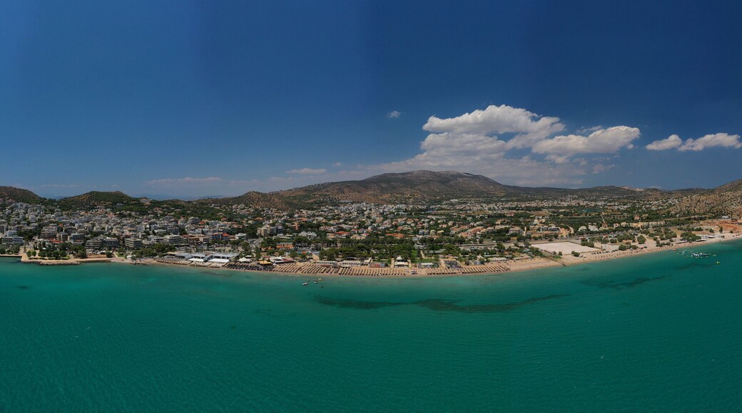 Aerial drone photo of famous seaside village of Varkiza with deep turquoise sandy beaches and clear blue sky, Athens riviera, Attica, Greece