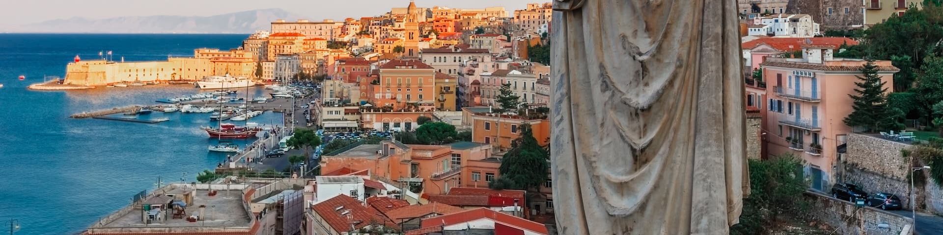 Panoramic sea landscape with Gaeta, Lazio, Italy. Scenic historical town with old buildings, ancient churches, nice sand beach and clear blue water. Famous tourist destination in Riviera de Ulisse