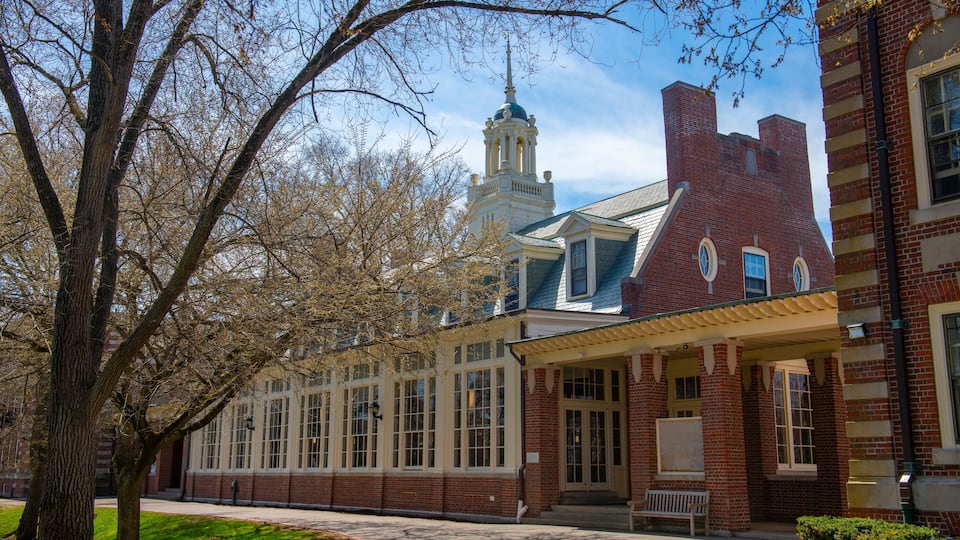 A historic building with a tower, large windows, and a brick facade.