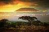 Mount Kilimanjaro and clouds line at sunset, view from savanna landscape in Amboseli, Kenya, Africa