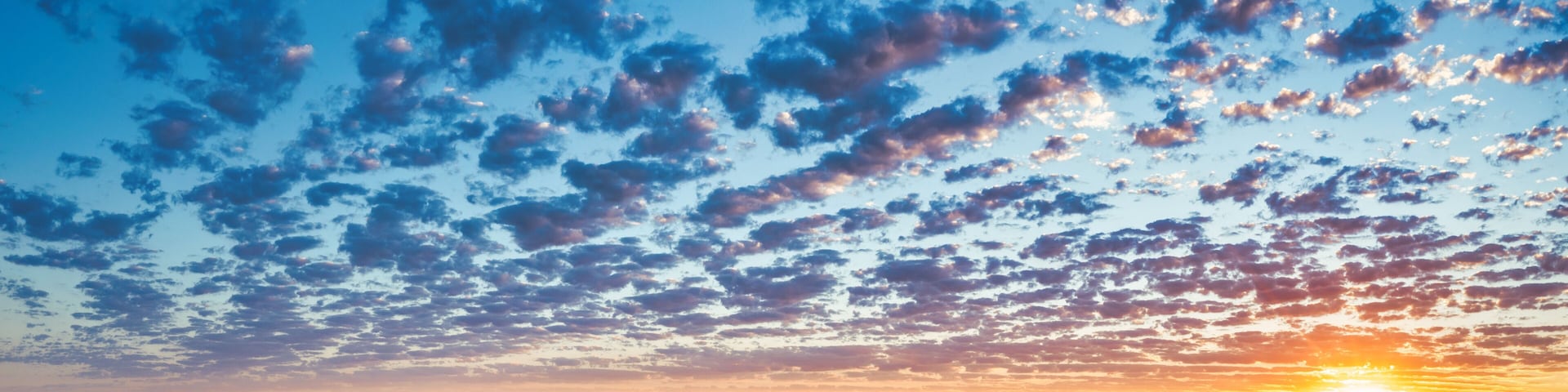Beautiful sunset with popcorn clouds in San Diego East County with mountain views.