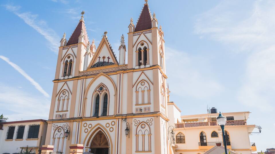 A large, ornate church with multiple spires and arched windows.