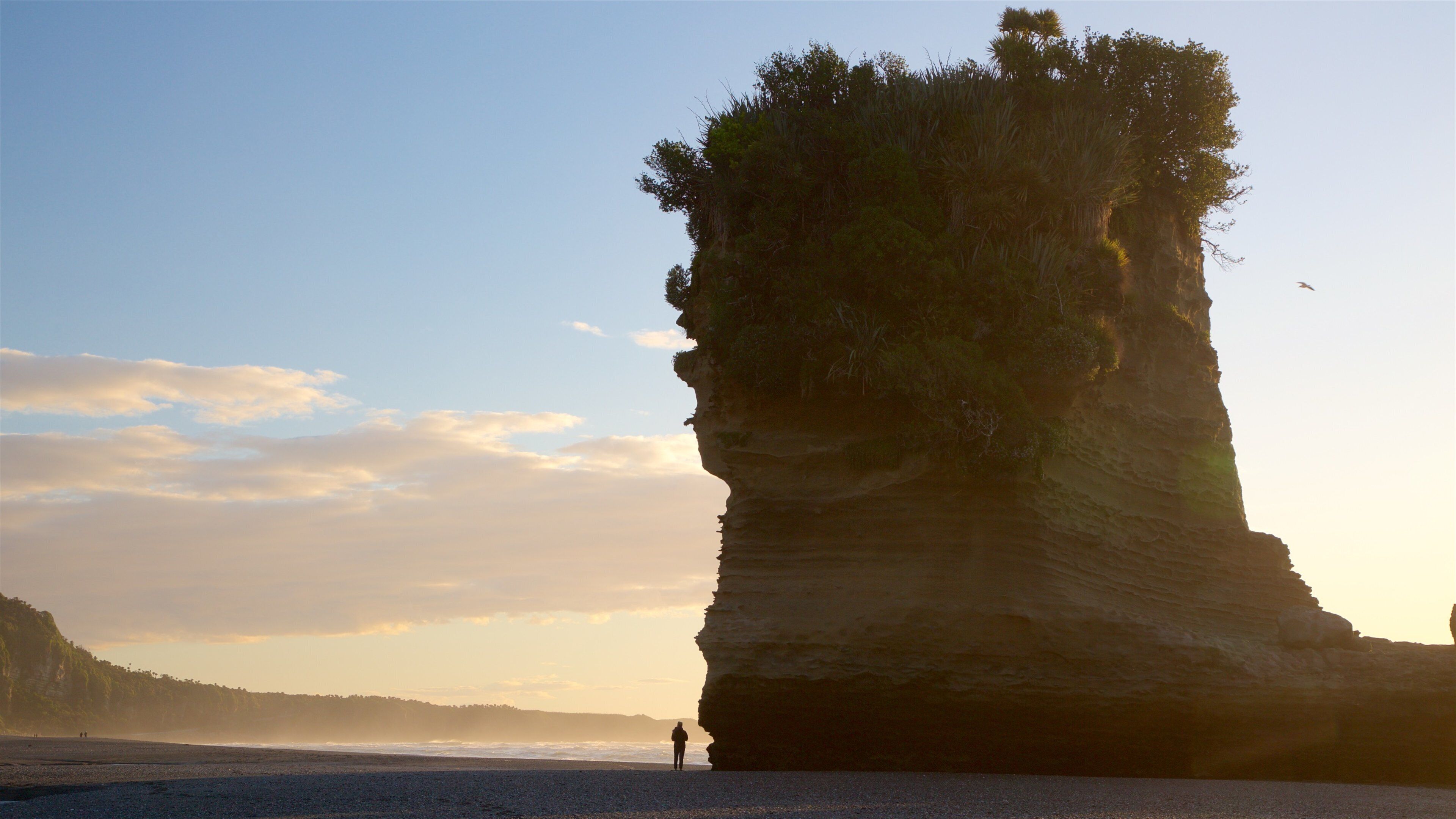 Punakaiki which includes mist or fog, a sunset and rugged coastline