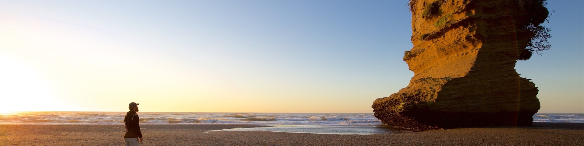 Punakaiki which includes a sunset and general coastal views
