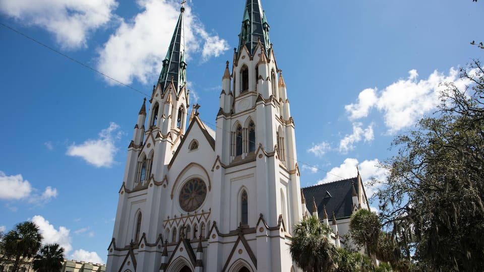 A white church with two tall spires and a large circular window.