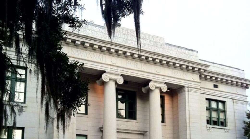 The history of the Live Oak Public Libraries can be traced back to the turn of the century in Savannah. Established in 1903, the Savannah Public Library consisted of a 23,000 volume collection housed in one room of the Georgia Historical Society. Ten years later the Carnegie Library opened on East Henry Street to serve Savannah’s black community.
Surrounded by late-Victorian homes and adjacent to a small city park modeled on the squares in historic downtown Savannah the main library building on Bull Street opened for use in 1916. The library was built at a cost of $104,041.78 with a Carnegie grant. Its neoclassical design was provided by architect H. W. Witcover, who also designed Savannah’s City Hall.