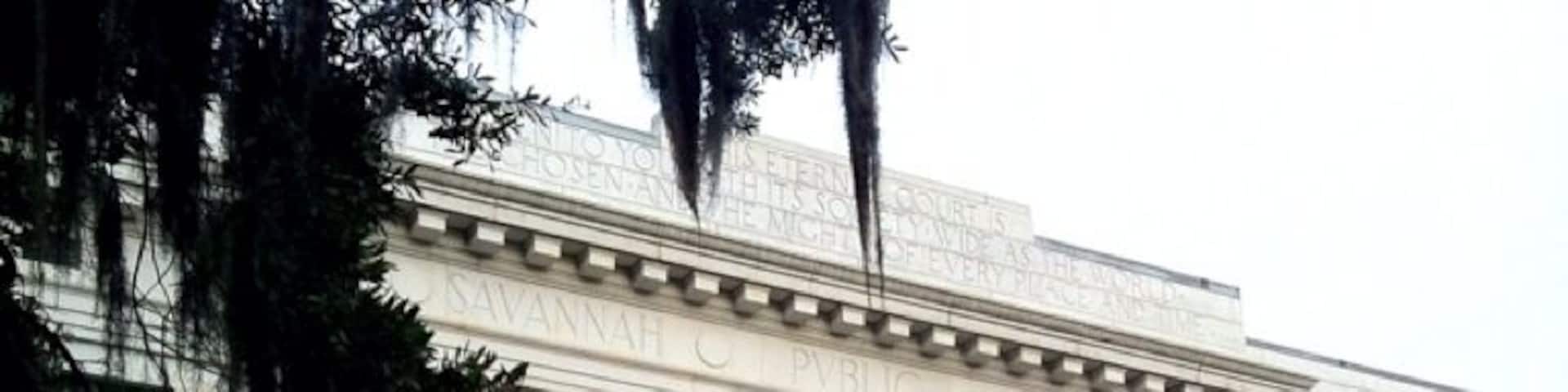 The history of the Live Oak Public Libraries can be traced back to the turn of the century in Savannah. Established in 1903, the Savannah Public Library consisted of a 23,000 volume collection housed in one room of the Georgia Historical Society. Ten years later the Carnegie Library opened on East Henry Street to serve Savannahâs black community.
Surrounded by late-Victorian homes and adjacent to a small city park modeled on the squares in historic downtown Savannah the main library building on Bull Street opened for use in 1916. The library was built at a cost of $104,041.78 with a Carnegie grant. Its neoclassical design was provided by architect H. W. Witcover, who also designed Savannahâs City Hall.
