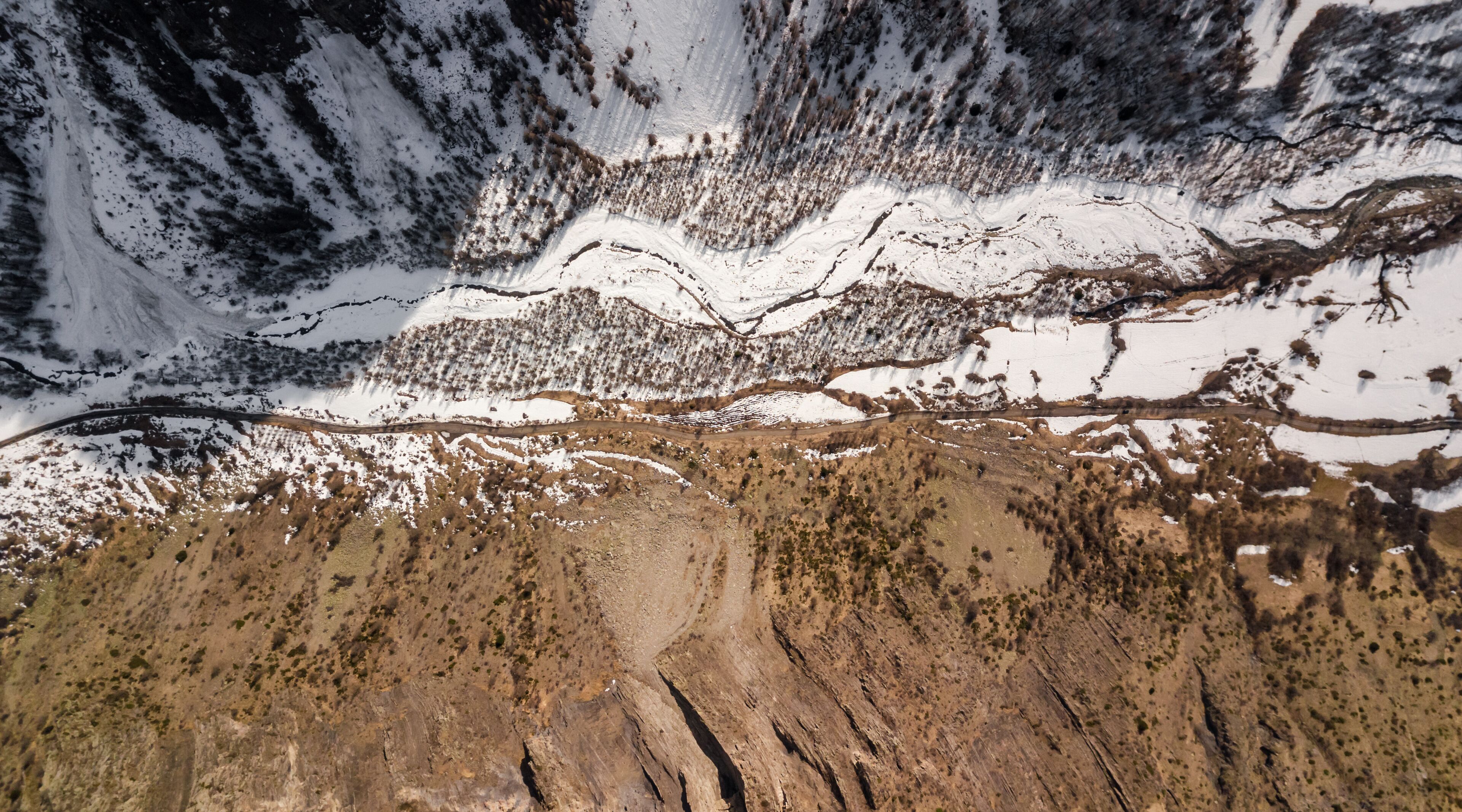 Drone view of alpine roads and trails down in the valley