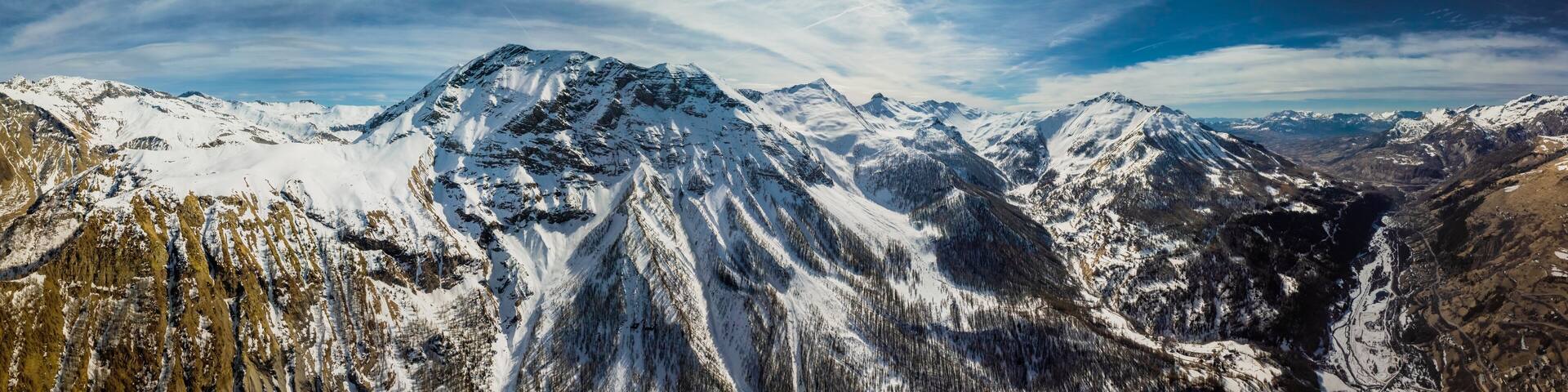 Panoramic drone view of the Alps with small village