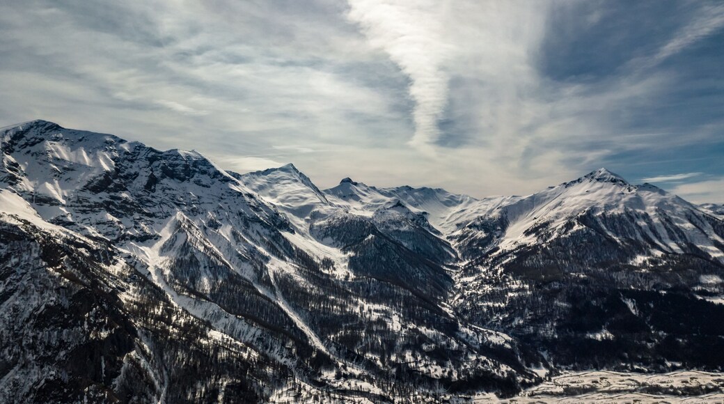 Drone view the Alps with forest and villages down the valley