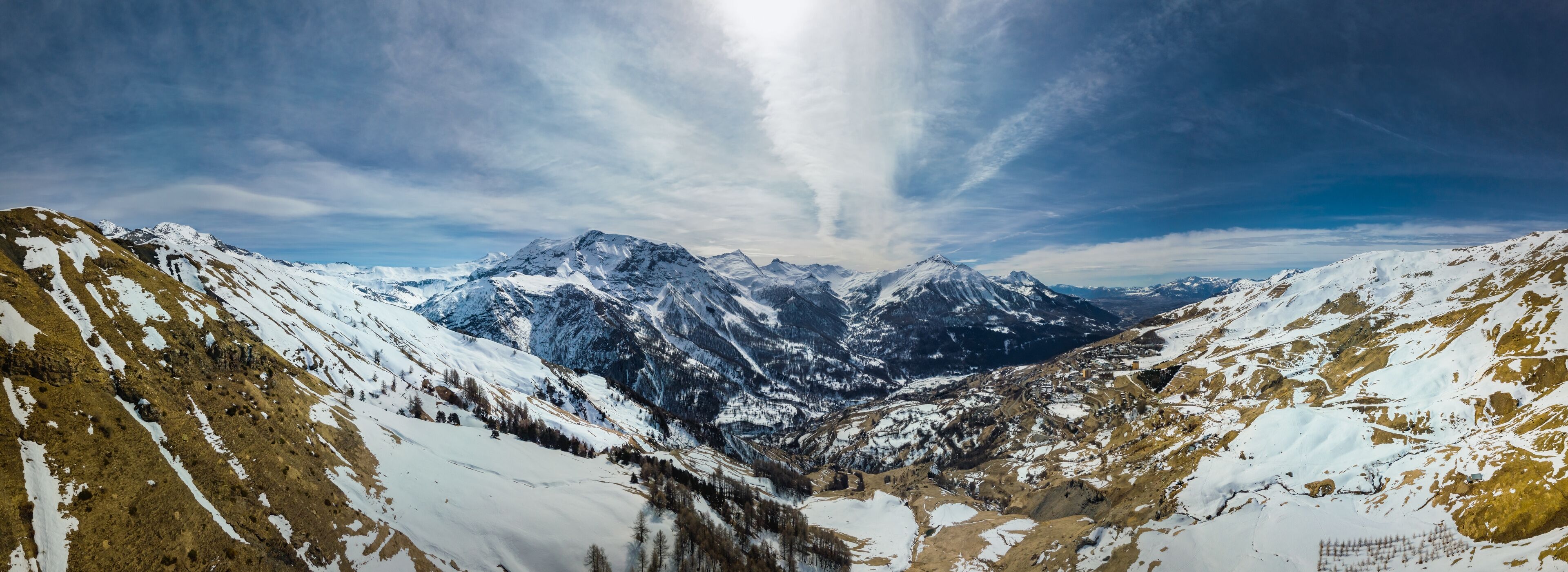 Panoramic drone view of the Alps with small village