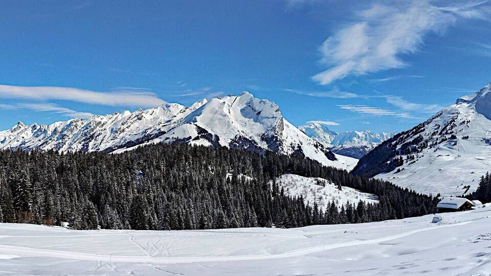 A snow-covered mountain range with a clear sky.