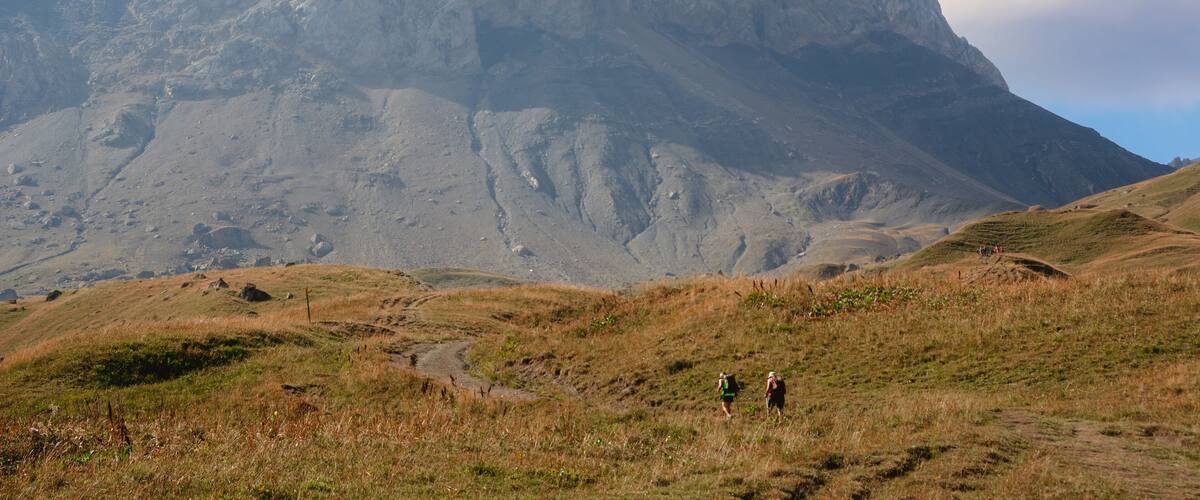 A mountainous landscape with two prominent peaks and a grassy valley.
