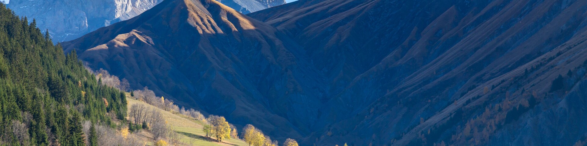 A mountainous landscape with a church and a church steeple.