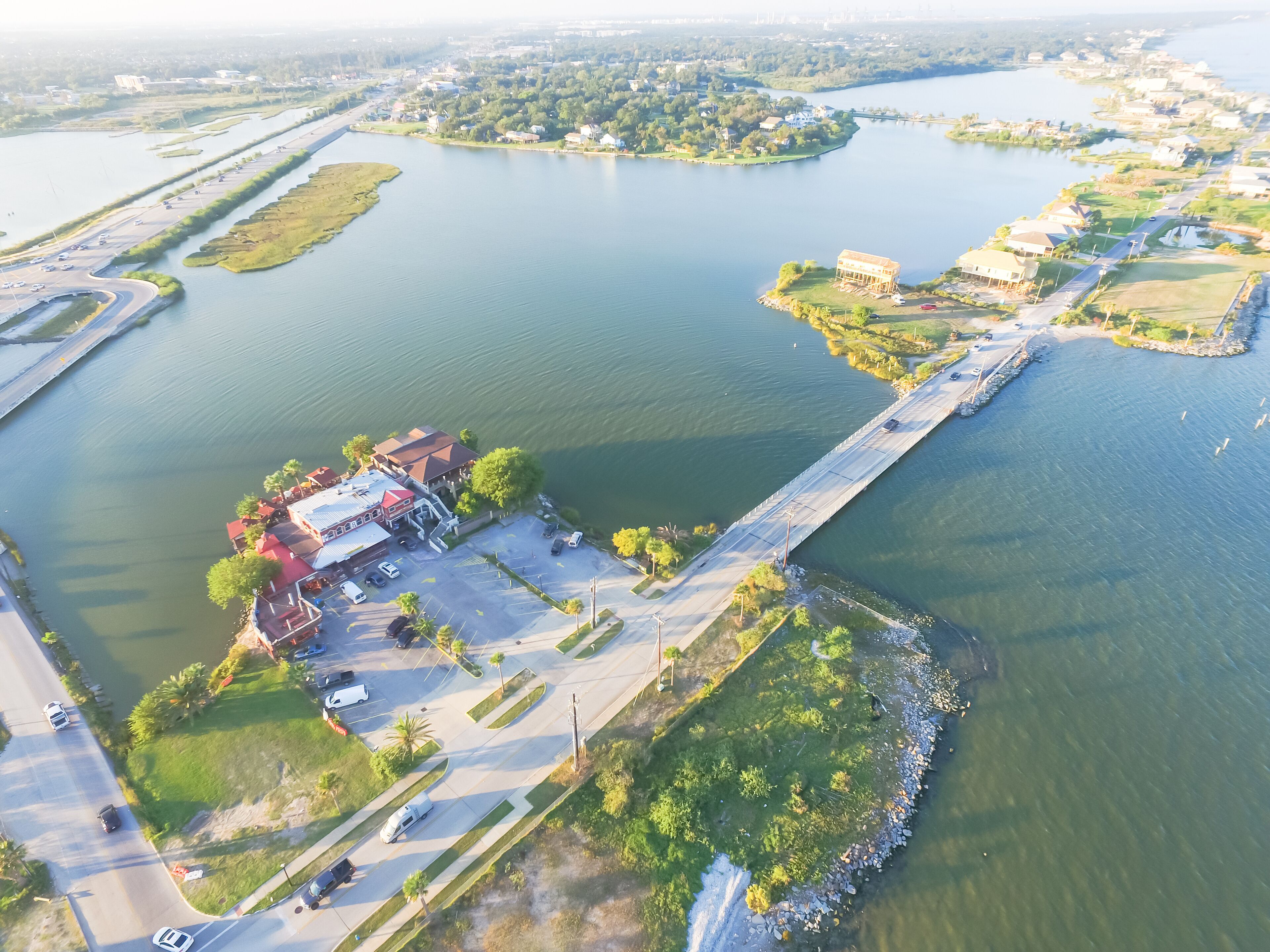 Aerial view of Seabrook city near Texas Gulf Coast and Clear Lake. Waterfront harbor town with pier. Wooden vacation house under construction. Real estate and beach travel background
