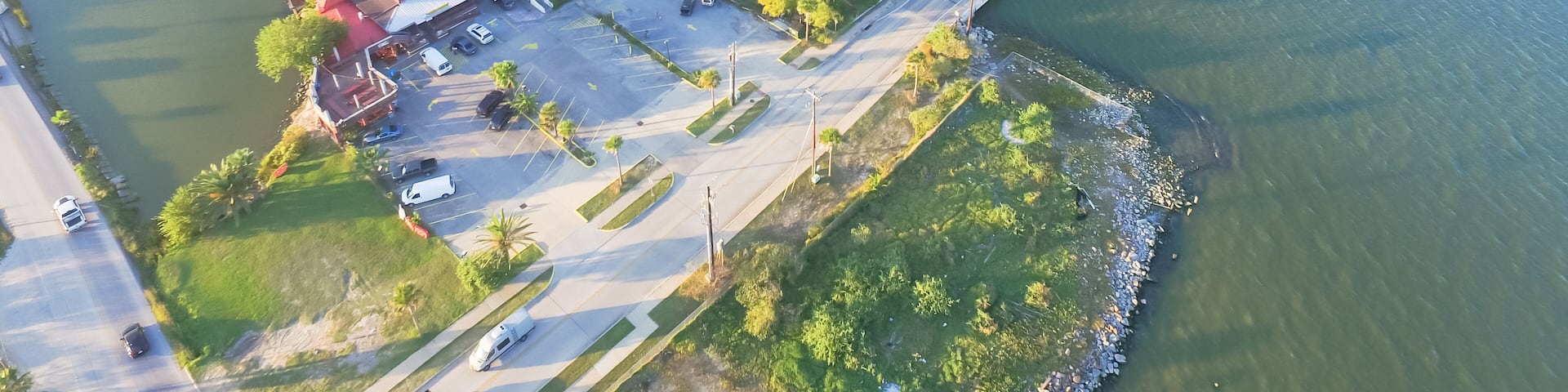 Aerial view of Seabrook city near Texas Gulf Coast and Clear Lake. Waterfront harbor town with pier. Wooden vacation house under construction. Real estate and beach travel background