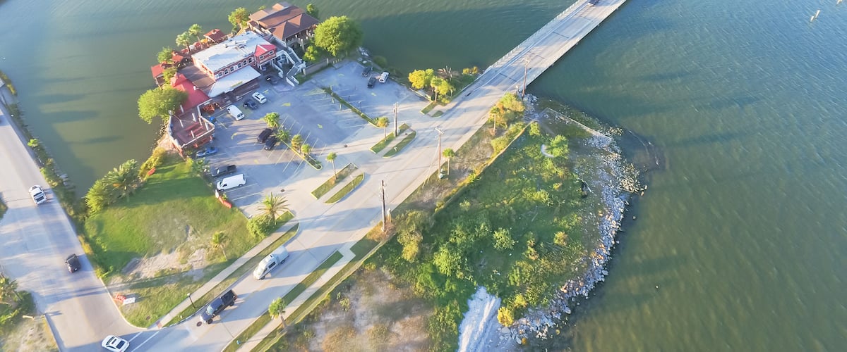 Aerial view of Seabrook city near Texas Gulf Coast and Clear Lake. Waterfront harbor town with pier. Wooden vacation house under construction. Real estate and beach travel background