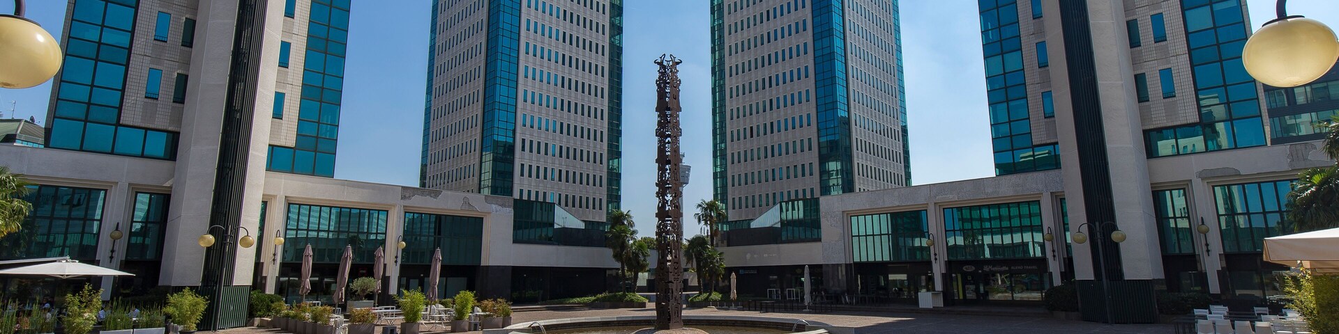 Vimercate, Italy - September 5, 2020: street view of the white towers, a shopping mall in the outskirts of Milan. No people are visible.