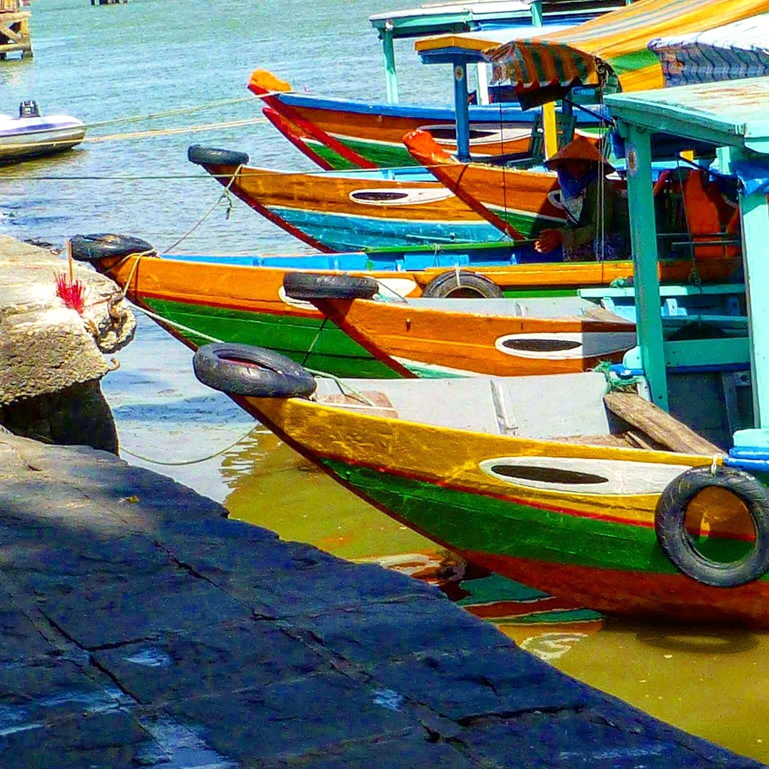 Eating lunch at a local tent on the river. I noticed the colorful boats lined up and it moved me