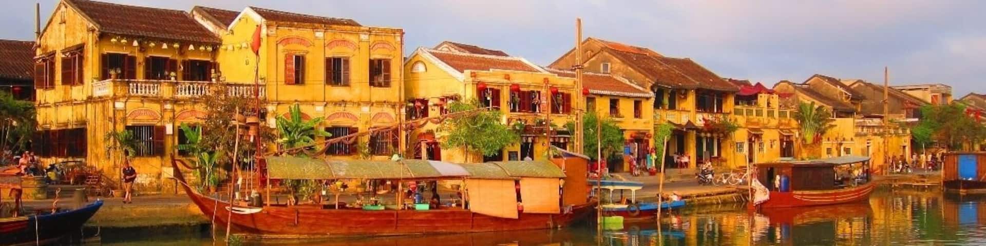 A riverside town with traditional buildings and boats.