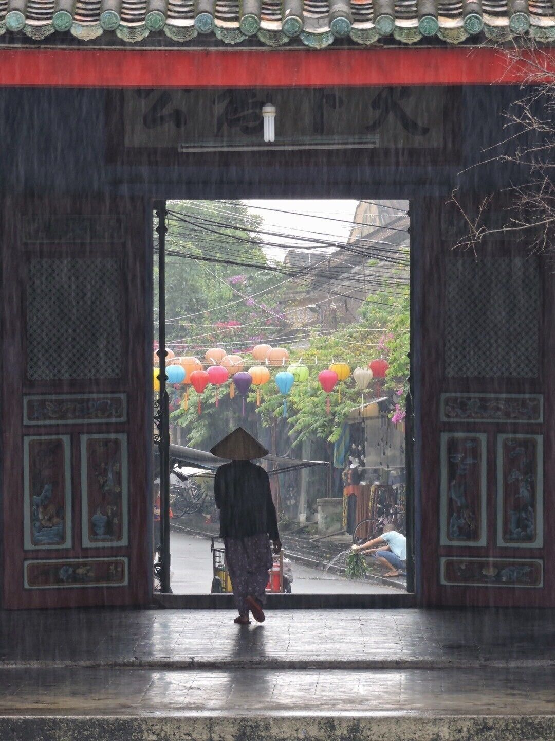 A traditional gate with a person walking through it.