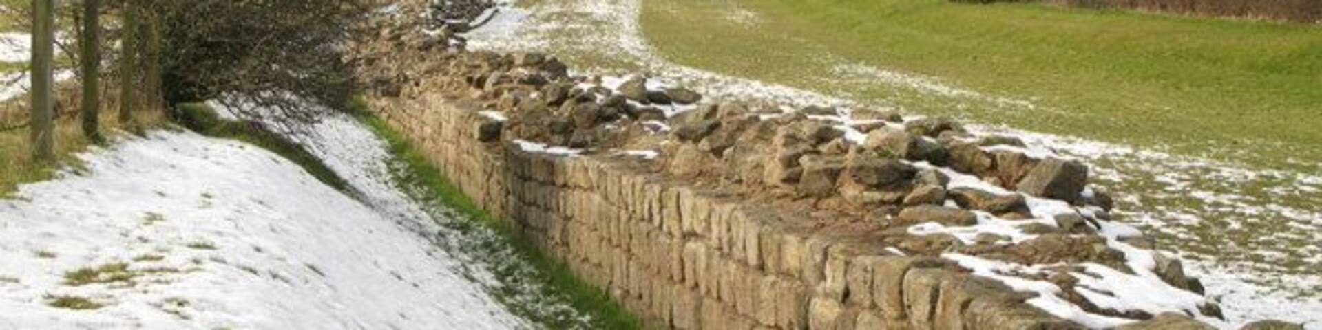The masonry of Hadrian's Wall The north defensive ditch can be seen to the right of the Wall.