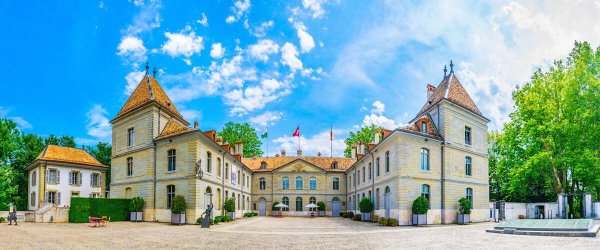 A large, historic building with two towers and a central courtyard.