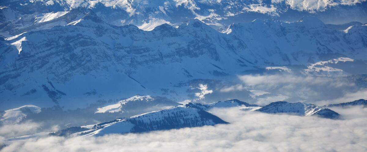 A snow-covered mountain range with peaks and valleys.