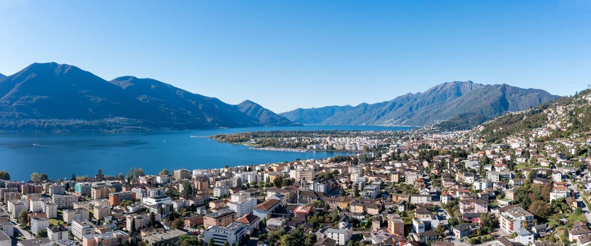 A coastal city with a mountainous backdrop and a large body of water.