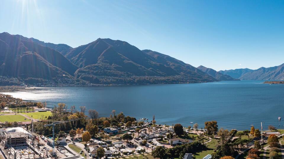 A mountainous landscape with a lake and a town.