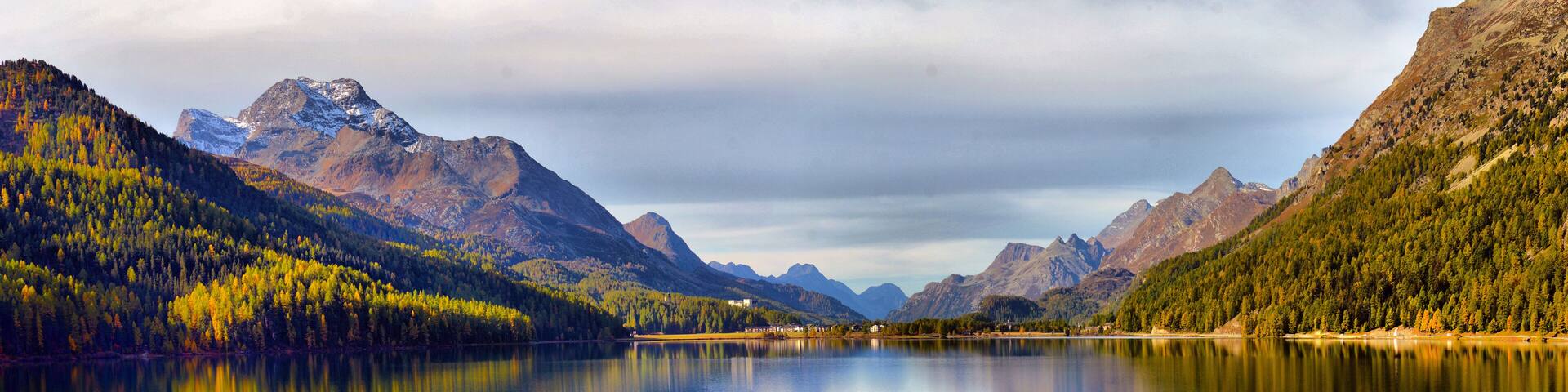 Mountain lake panorama with mountains reflection. Idyllic look. Autumn forest. Silvaplana Lake, Switzerland