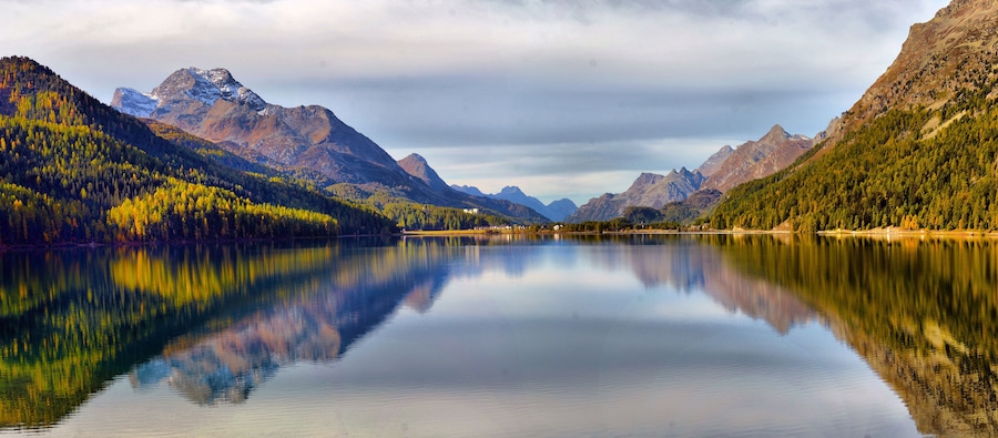 Mountain lake panorama with mountains reflection. Idyllic look. Autumn forest. Silvaplana Lake, Switzerland