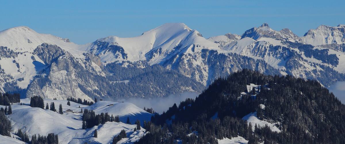 A snow-covered mountain range with clear skies.