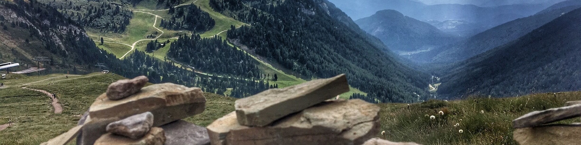 After taking the gondola and ski lift to near the top of the mountains in Predazzo it's hard not to be impressed by the view, you can even add your own stone onto one of the mountain cairns up there. The alpine lodge is a great place to stop for a drink and slice of cake too.