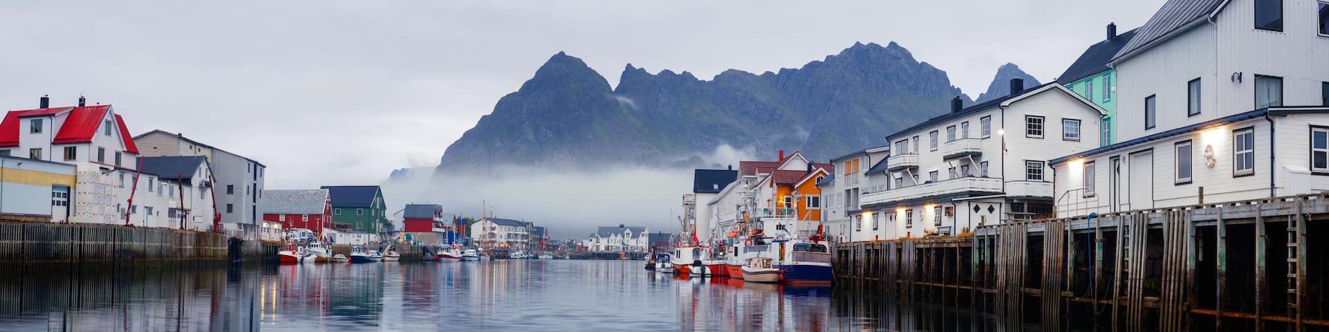 Scenic view of the waterfront harbor in Henningsvaer in summer. Henningsvaer is a fishing village and tourist town located on Austvagoya in the Lofoten Islands. Norway.