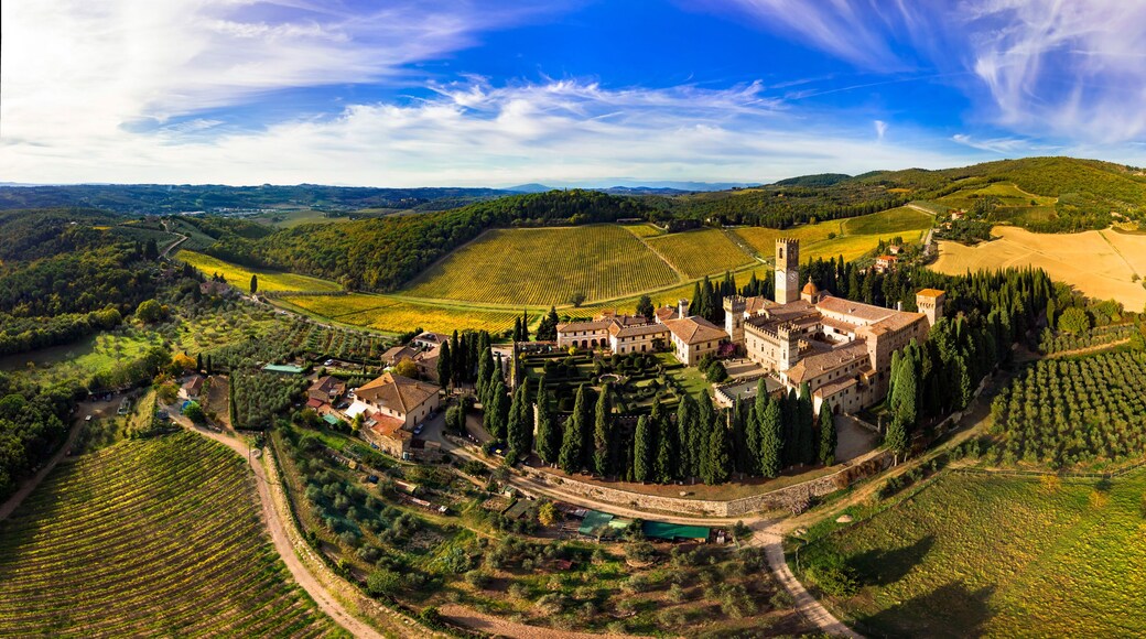 Badia a Passignano Italy aerial panorama in 12k high resolution. Chianti Classico wine region Tuscany. Medieval abbey and village surrounded by vineyards and cypresses. World Print quality scenery