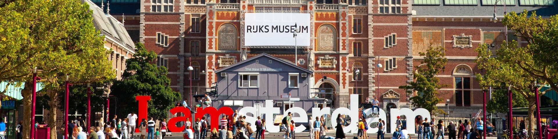 Rijksmuseum which includes heritage architecture, signage and a pond