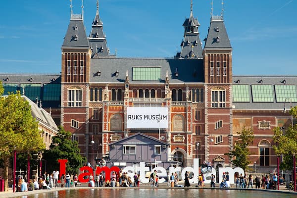 Rijksmuseum which includes heritage architecture, signage and a pond