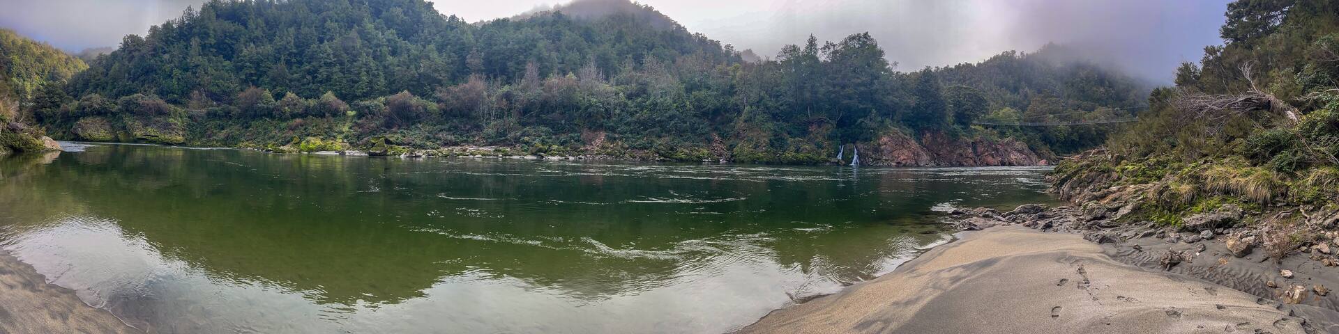 The Buller river flowing through the forest covered upper Buller Gorge near the longest suspension bridge in NZ