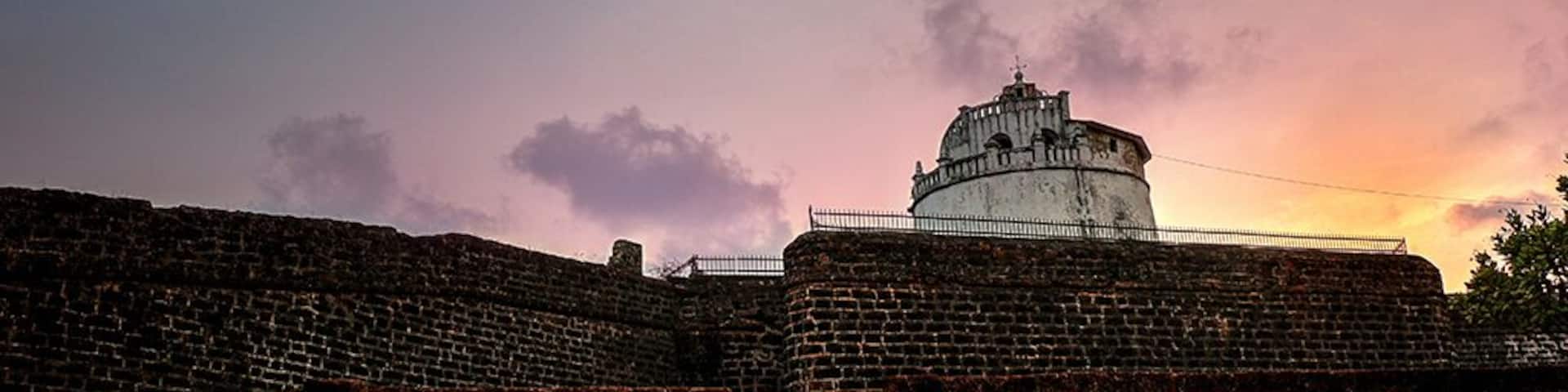 A historic fort with a dome structure, brick walls, and a staircase leading up to it.