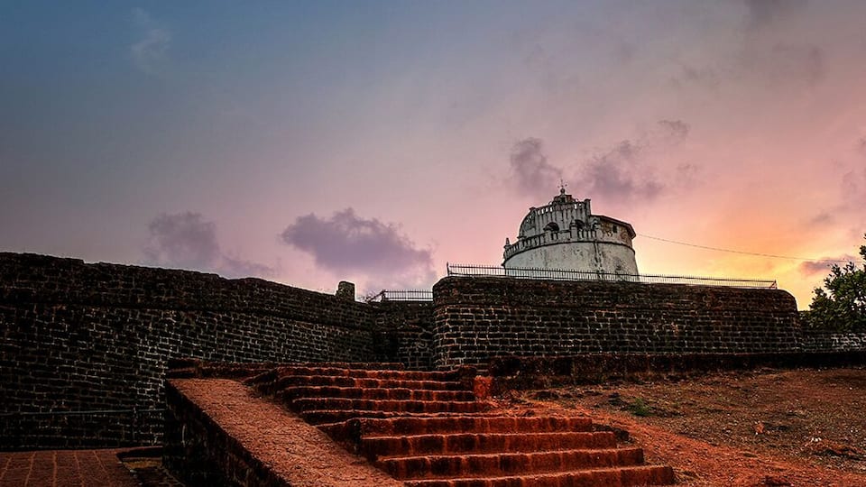A historic fort with a dome structure, brick walls, and a staircase leading up to it.