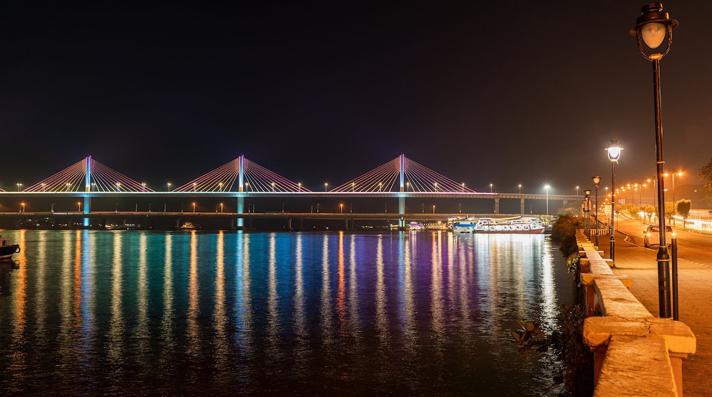 Beautiful view of the well illuminated Mandovi River Bridge in moonlight, with reflection of colored lights in river. Locally known as Atal Setu, this is one of the largest cable stayed bridge.