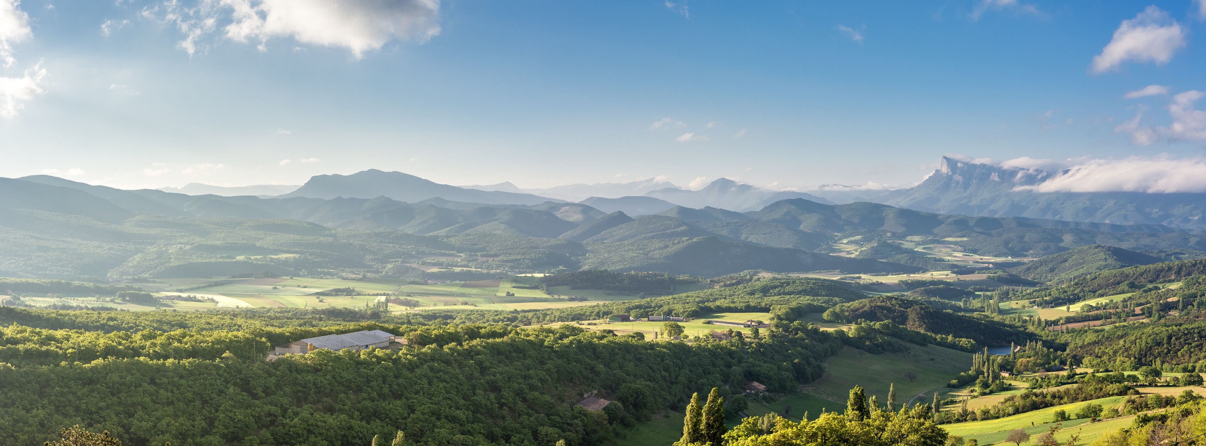 French countryside. View over the mountains (Trois Becs, Plateau des Chaux, Grand Barry et la Servelle) of the Drôme in France.