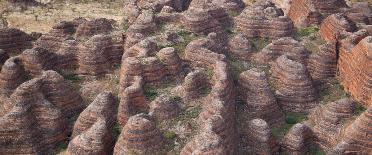A landscape of tall, narrow rock formations with layered patterns.