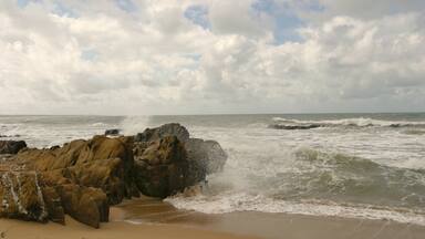 La Pedrera showing a sandy beach and rugged coastline