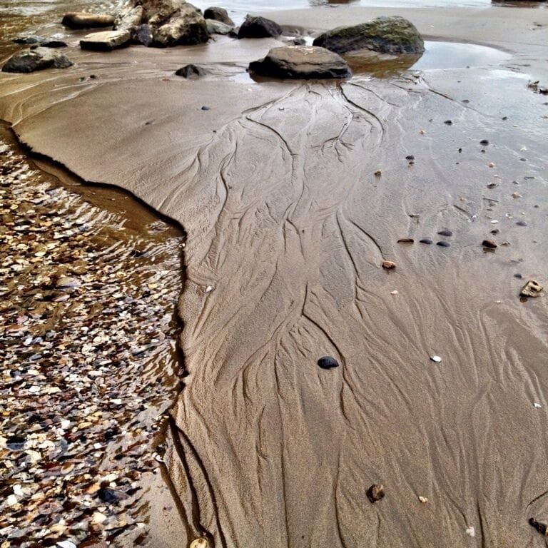 À small brook passes thought The river sand into The river rhine. 