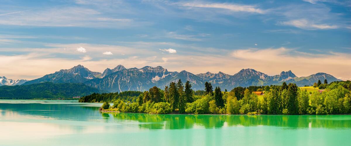 panoramic landscape in Bavaria with mountain range and lake